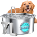 Dog next to a large metallic pet water fountain with water flowing.