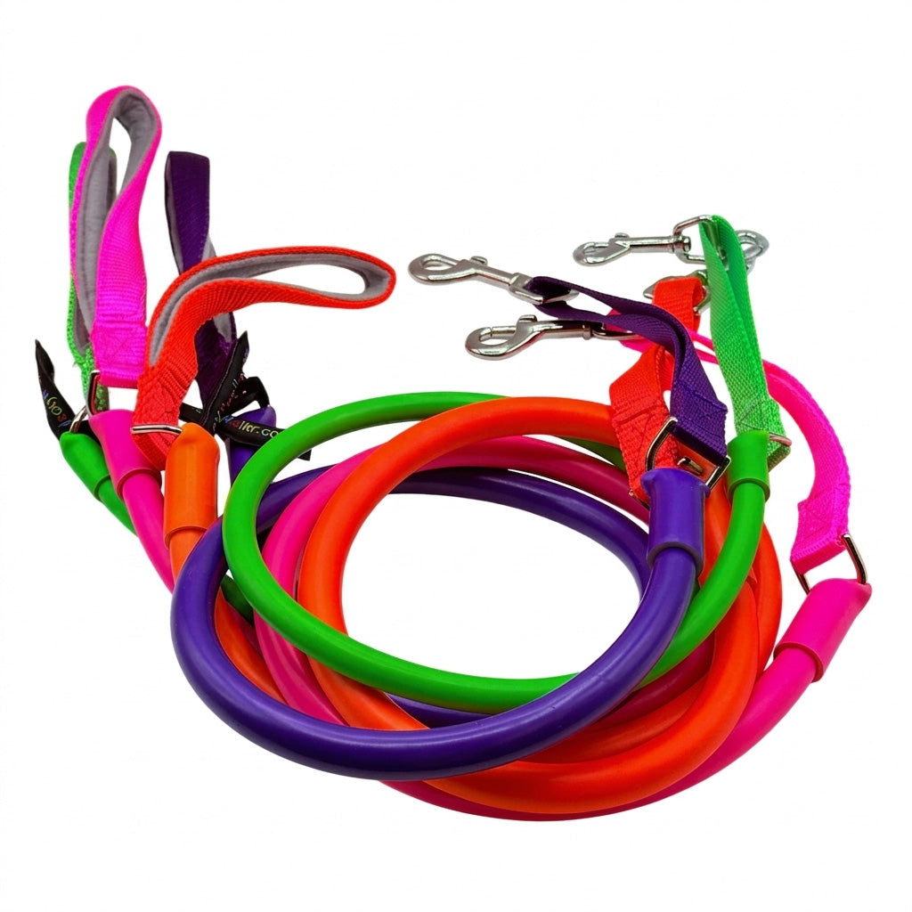 A set of colorful dog leashes with matching handles and silver metal snap hooks, arranged in a pile on a white background.