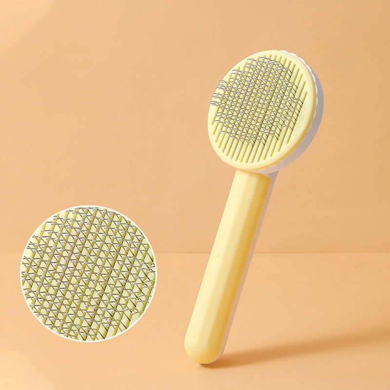 Yellow pet grooming brush with close-up of bristle texture on a beige background