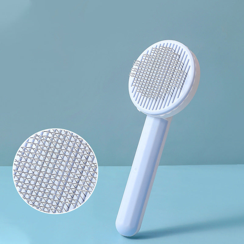 White handheld brush with textured head on a light blue background