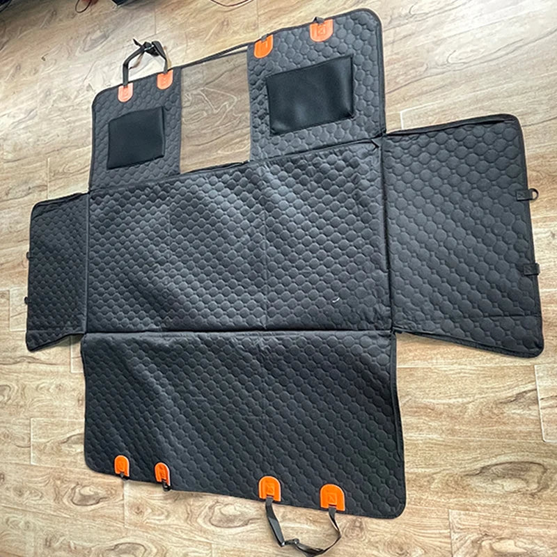 Black car mat with orange accents on a wooden floor
