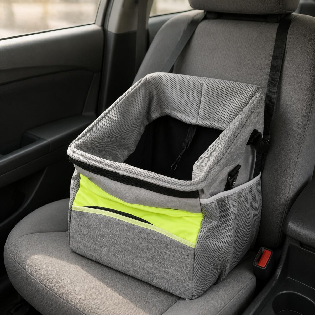 A gray mesh car seat pet booster seat with a bright neon yellow-green accent panel, shown installed on a gray car seat.
