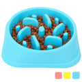 Blue slow feeder dog bowl with brown kibble inside on a white background