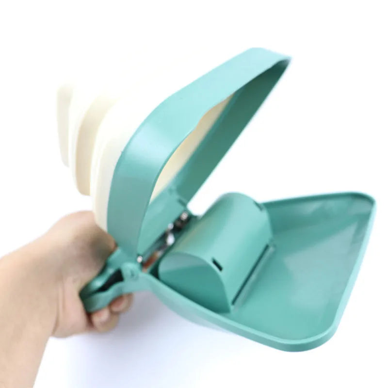 Teal dustpan held by a hand on a white background