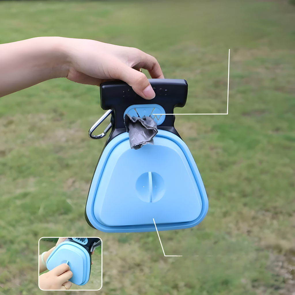A light blue and black outdoor fly tying tool held by a person's hand, shown against a blurred grassy background. The image includes a small inset demonstrating the tool being worn on a wrist.