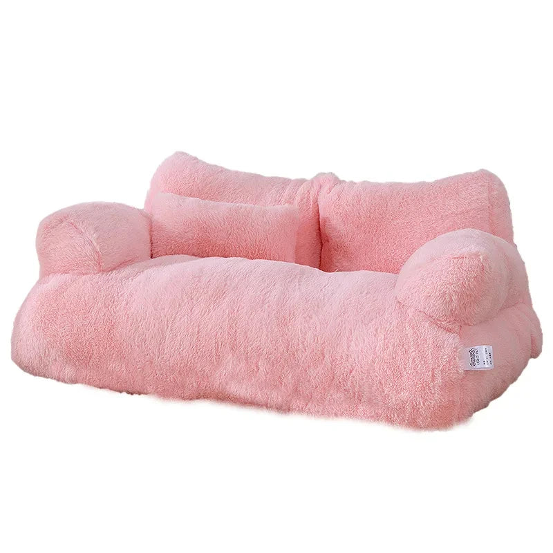 Pink plush pet bed on a white background