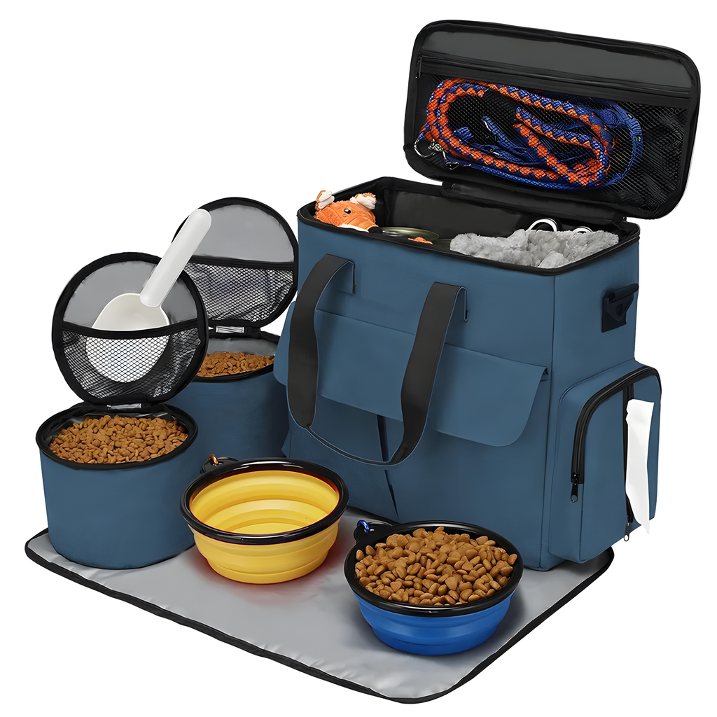A blue pet feeding and storage bag set shown open on a white background, with bowls of kibble, a yellow collapsible bowl, a scoop in a mesh container, a leash, and storage compartments inside the bag.