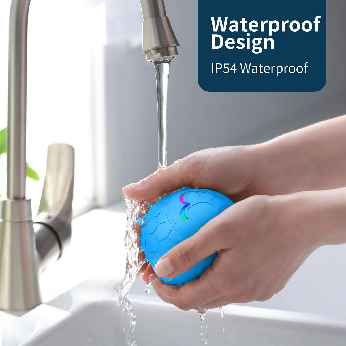 Blue ball with colorful design being rinsed under running water in a sink, labeled 'Waterproof Design IP54 Waterproof'.