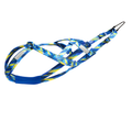 A blue and yellow patterned dog harness with reflective silver stripes and a black metal clip, shown on a plain white background.